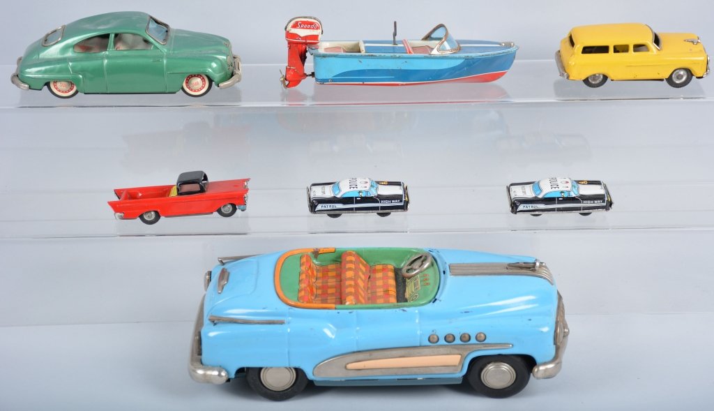 Lot of 7 Japan Tin CARS and BOAT: Includes 11" Tin Friction Buick, Tin Friction Saab, Windup Boat with outboard motor, and others. Very Good-Excellent