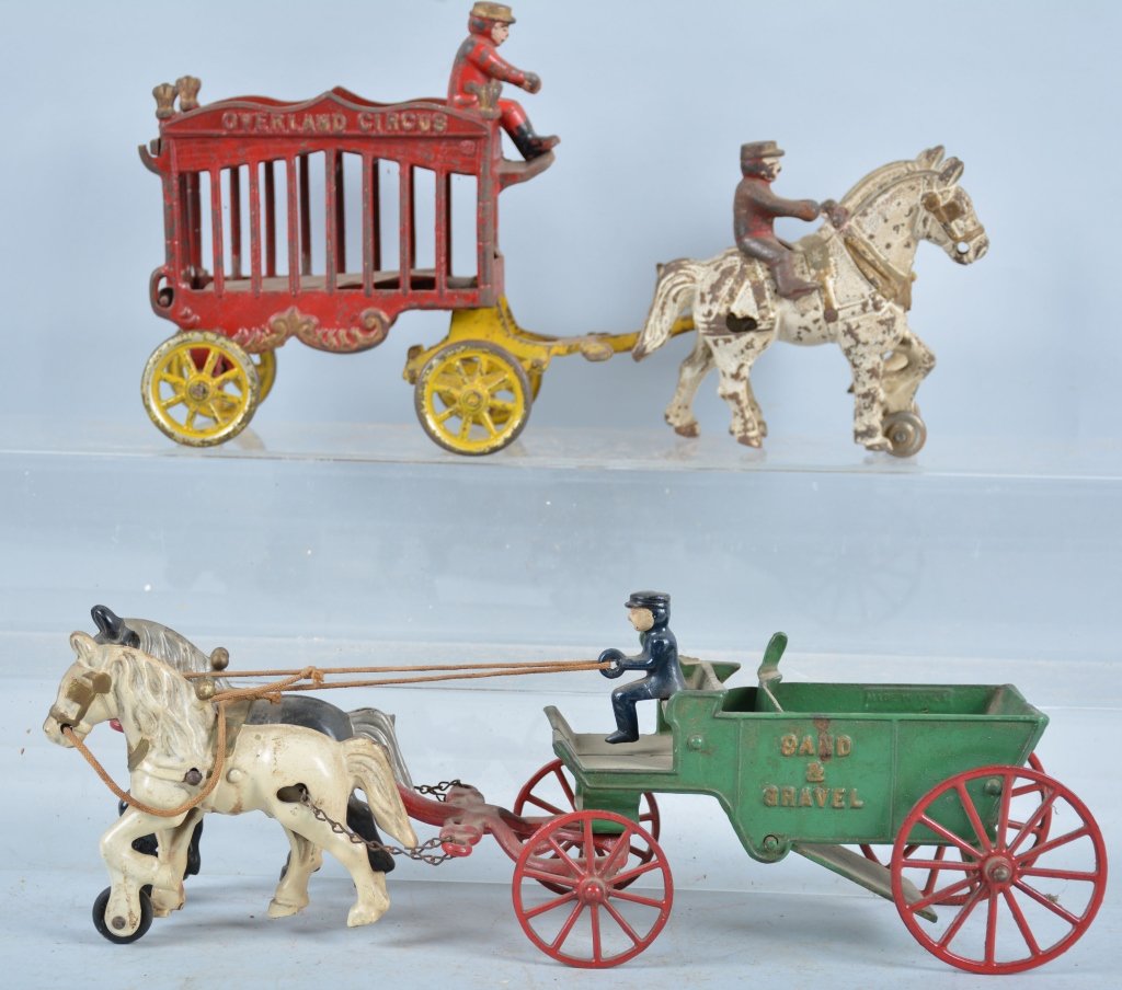 Lot of 2 Cast Iron Kenton Toys: Circus Wagon and Sand and Gravel wagon, both original paint, largest 14", Good-Very Good
