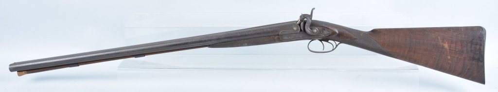 1850's Scott & Son's Shotgun, London: Double barrel percussion shotgun with tiger stripe stock. Bore is good, and has original ram rod. The barrel has pitting and the nipples are replaced. Action may need adjustment. Heavy well made mid 1