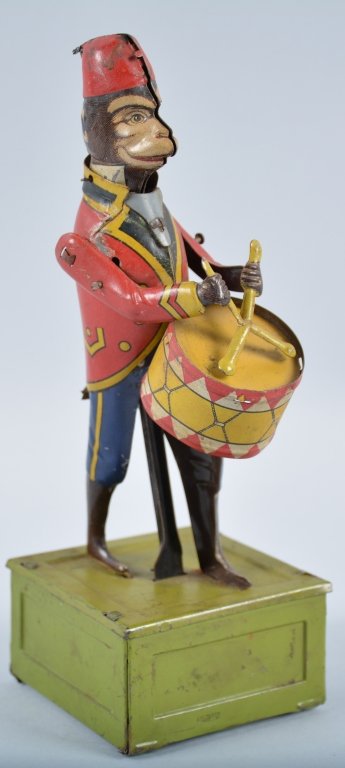 DITSLER Tin Windup MONKEY DRUMMER: Very colorful toy made by Ditsler of Germany. Toy is all original with great colors and graphics. Monkey is missing his tail. Works. Very Good