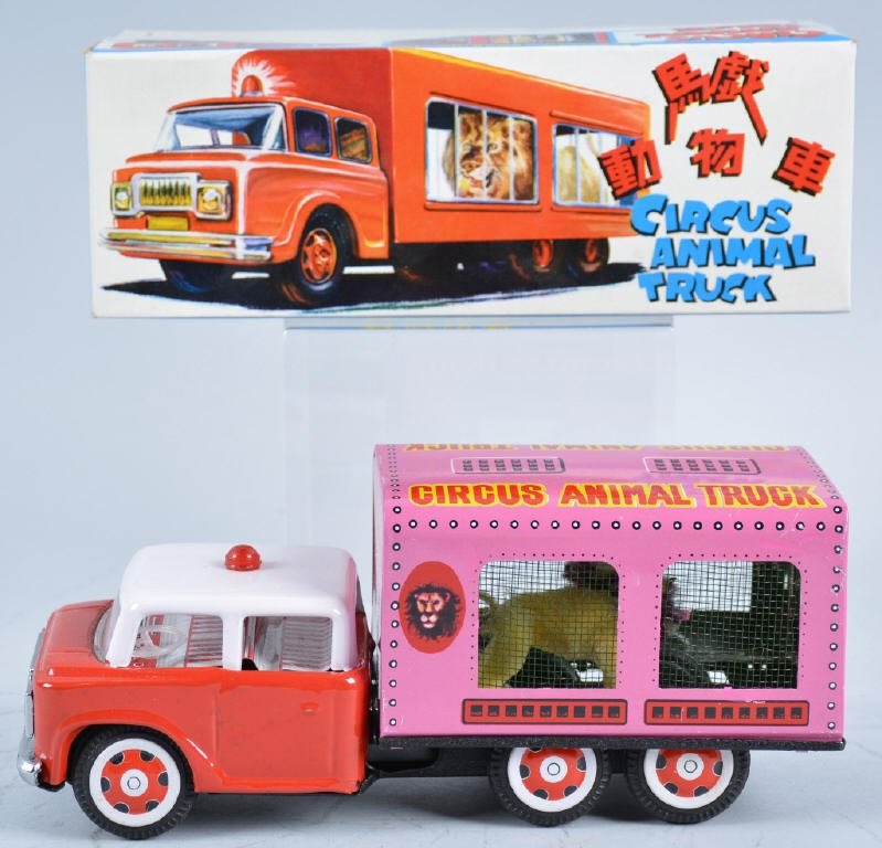 RED CHINA Tin Friction CIRCUS LION TRUCK w/Box: Excellent truck with Lion in cage on the back. Very nice c olors and graphics. 9" Long. New Old Stock in Box. Near Mint
