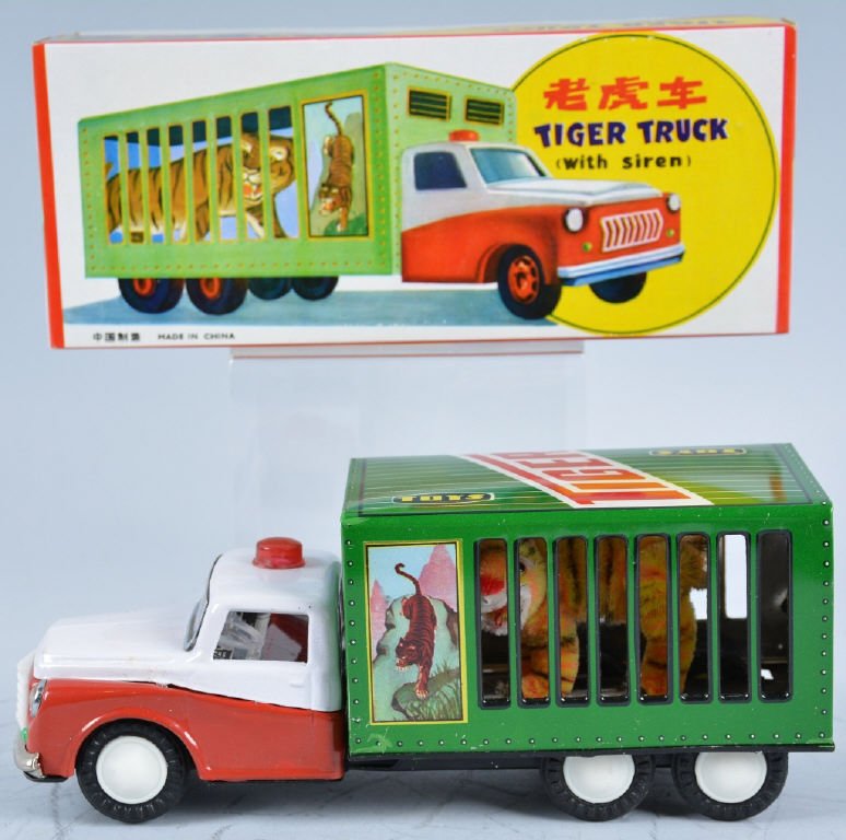 RED CHINA Tin Friction TIGER TRUCK w/Box: Great looking tin frction tyruck. Has very cute looking tiger in cage on back. Truck has friction siren action. 10" Long. New Old Stock in Box. Near Mint