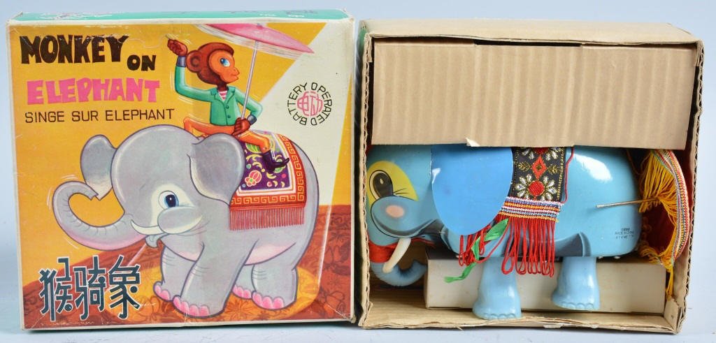 RED CHINA Battery Op MONKEY ON ELEPHANT w/Box: Excellent looking toy! Whimiscal monkey with celluloid persol riding a tin elephant. Very colorful toy! New Old Stock in Box. Near Mint