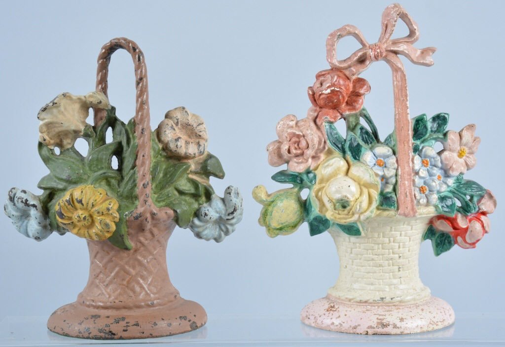 Lot of 2 Vintage Cast Iron Doorstops: Two basket of flowers door stops, with the largest 10 1/2" high, nice details, one has over paint, Good-Very Good
