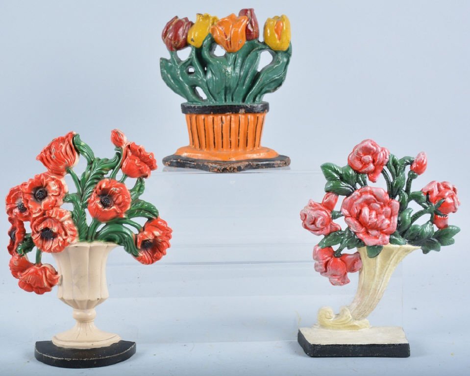 Lot of 3 Cast Iron Door Stops: 3 Basket of Flowers doorstops, largest is 11", the slanted base appears to be contemporary, the tulips are an old repaint, Good-Very Good