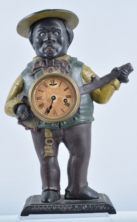 Cast Iron Minstrel with Banjo Clock: Nicely detailed contemporary clock in working condition, a faithful and nicely made copy of an original, 15 1/2" high, Excellent