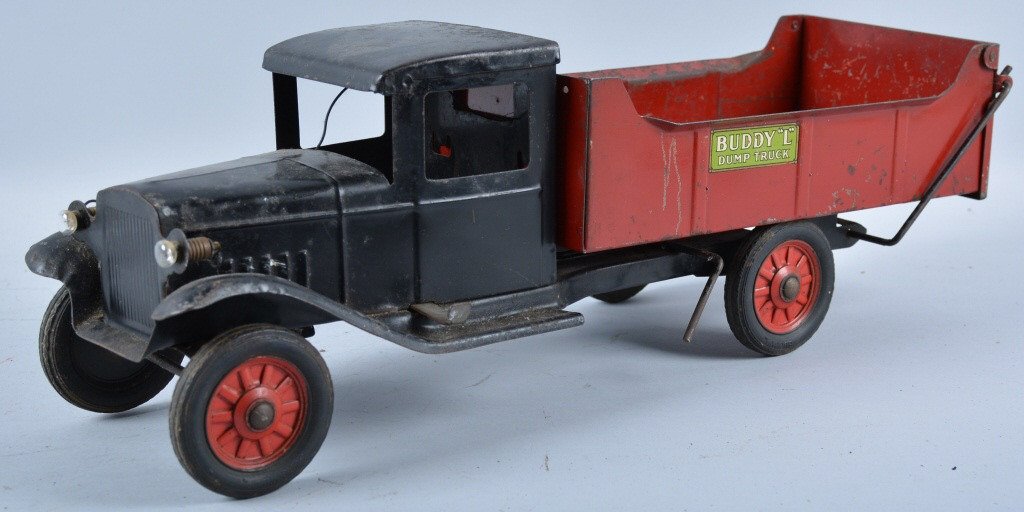 BUDDY L Pressed Steel ELECTRIC LIGHT DUMP TRUCK: Nice early Buddy L Truck. All original and measures 20" long. Ni ce paint and decals. Does have some wear and scratches. Unusual electric headlight version. May clean to higher grade. Very Good