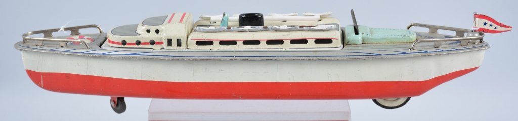 JAPAN Tin Friction BATTLESHIP OR CRUISE SHIP: Very unique Japan Tin Friction toy ship. The center of the ship rotates to be a Battleship or Cruise Ship. Measures 12" Great colors and details. Excellent