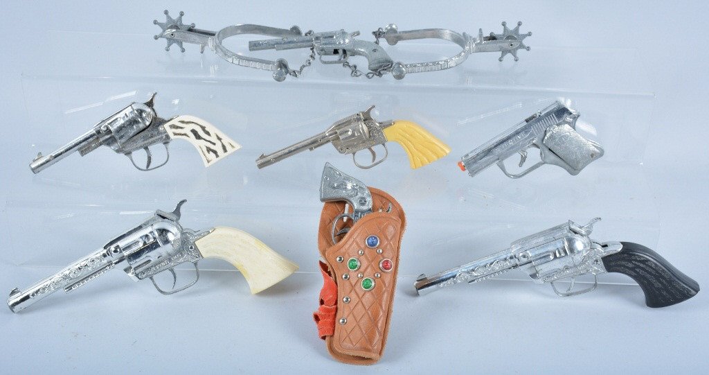 Lot of 7 VINTAGE CAP GUNS: Nice lot of 7 Vintage Cap Guns. Makers include Hubley, Leslie Henry, and More. Includes Detective, Pony Boy, Texas, and more. Also includes set of Spurs. Very Good-Excellent