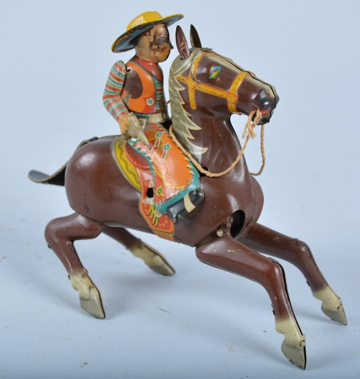 Japan COWBOY ON HORSE HOPPER: Nicely detailed tin cowboy on horse. Toy is all original with nice colors. Missing remote to make it hop. Very Good