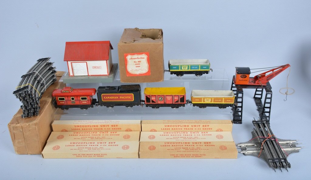 VINTAGE MARX and AMERICAN FLYER TRAIN LOT: Includes 4 Marx Train Cars, Marx Wrecker Crane, Marx Train Track, Marx case box of 6 Uncoupling Unit Sets, American Flyer Tool Shed with Box. Very Good-Excellent