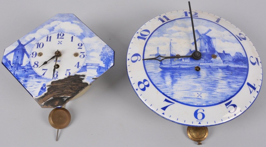 Lot of 2 DELFT BLUE & WHITE WALL CLOCKS German: Nice lot of 2 beautiful Wall Clocks made in Germany. Both all original and complete. Smaller does have some loss to the face. Larger clock is in beautiful condition. Both are working. largest measures