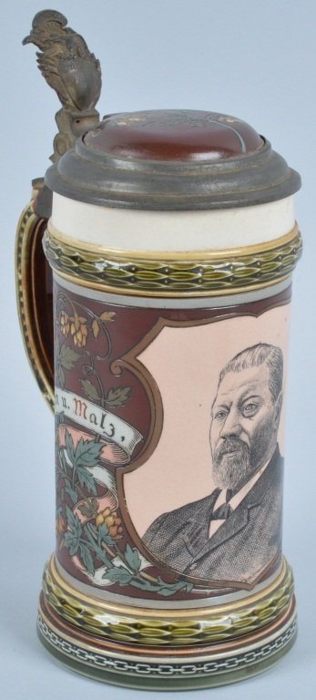 METTLACH STEIN with PORTRAIT 1885-1930: METTLACH STEIN. Impressed castle mark for 1885-1930 with form #1997 (George Ehert). Shield medallion with portrait of a gentleman. Impressed foliage with banners "Hopfen u. Malz, Gott erhalt's". Shiel