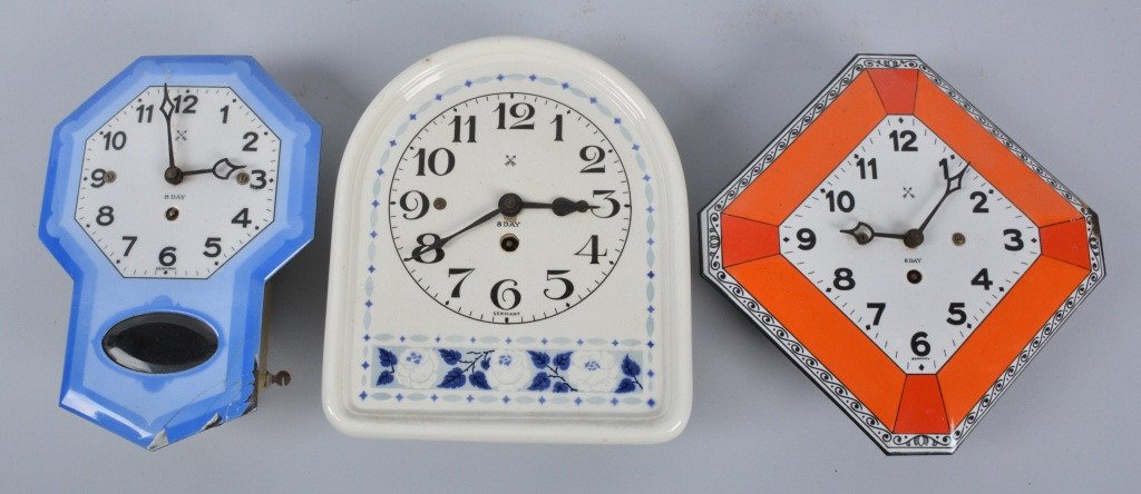 Lot of 3 VINTAGE GERMAN CLOCKS: Very nice lot includes 2 Porcelain over Metal 8 Day Clocks. Both with very nice colors. Slight loss on the edge of the blue clock. Also included is a ceramic 8 Day clock. All 3 are key wind. All marke