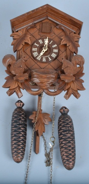 German Cuckoo Clock: Nice clock with carvings of squirrels, Measures 10" by 8", Excellent