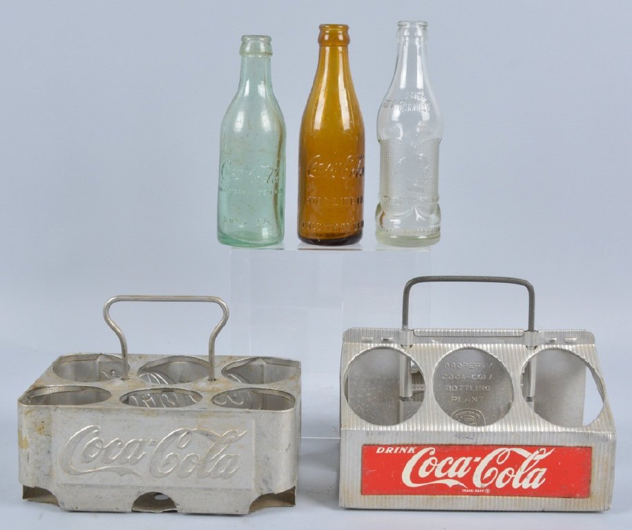 Coca Cola Lot, Bottles & Carriers, Vintage: Great lot with an Amber Coca Cola bottle from Columbus Ohio, and early turquoise bottle from Rome, Georgia, 2 different aluminum carriers, and Big Chief soft drink bottle. Condition varies, Very Good-