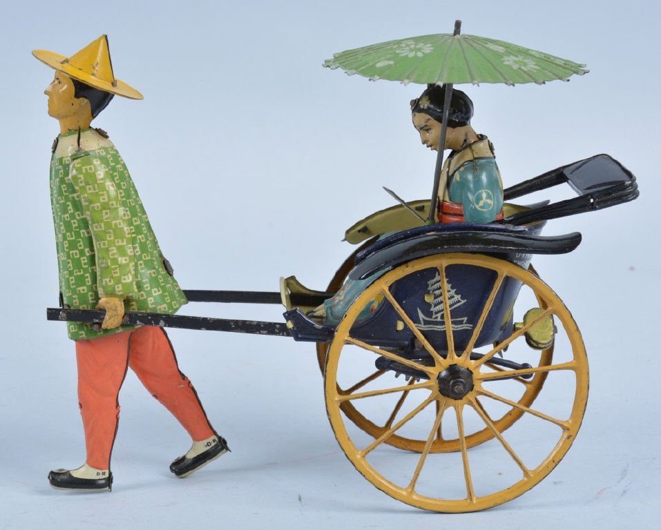 LEHMANN Tin Windup MASUYAMA: This Masuyama is a truely Breath Taking Example of the most beautiful toy Lehmann produced!! It looks NEVER played with condition. The toy is 100% original including the Umbrella, Fan, and Fenders. Th