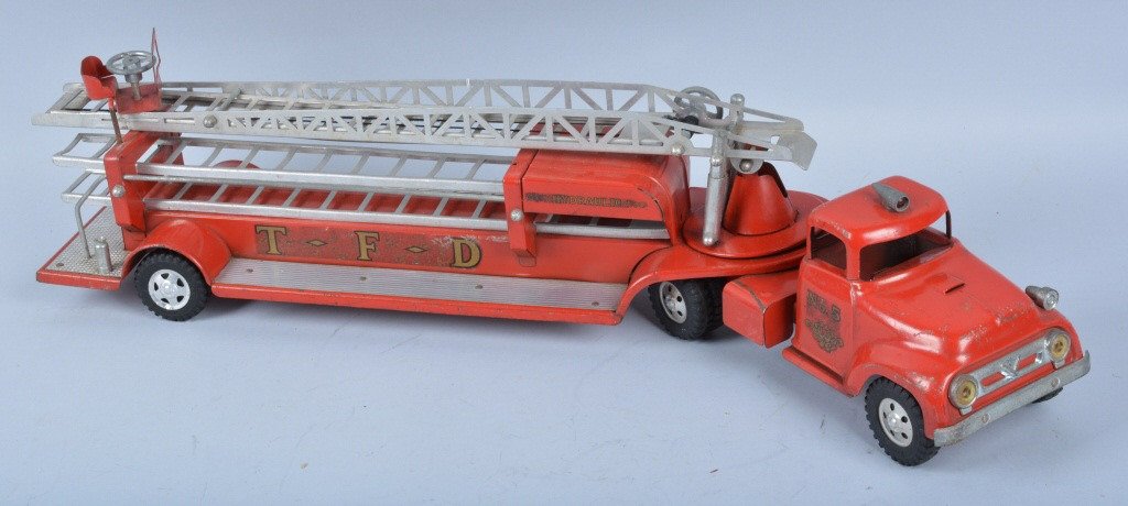 TONKA Pressed Steel ARIEL LADDER TRUCK: Nice original Tonka from 1957 Ariel Ladder Truck. Truck is all original with very nice paint and decals. Has accessory ladders. Few scratches throughout but a nice looking truck. Measures 31" long. Ve