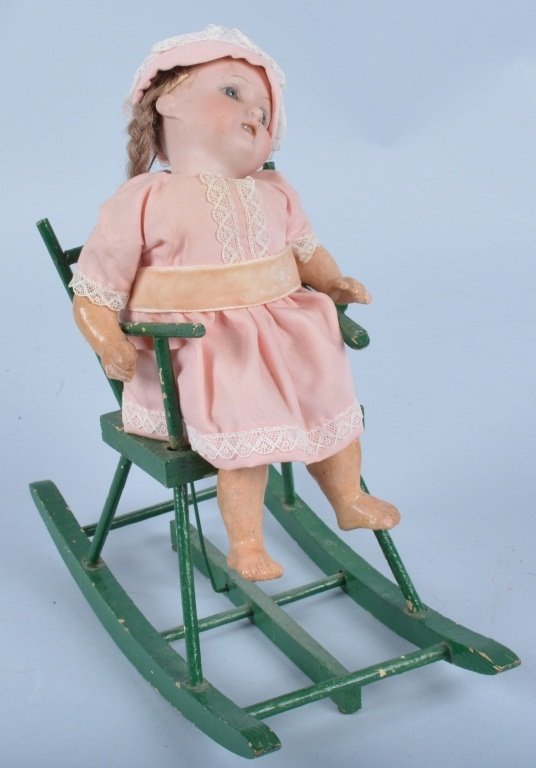 A&M Germany Bisque Windup Doll in Rocking Chair: Scarce A&M doll in the original windup rocking chair. Windup mechanism slips. Doll is very nice but strings need tightened. Excellent