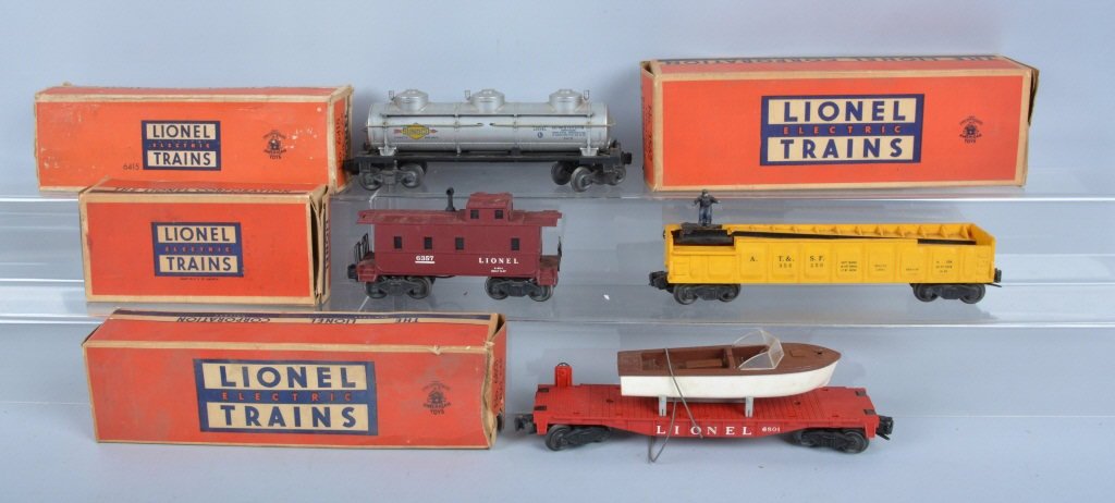 Lot of 4 LIONEL TRAINS CARS w/Box: Includes Lionel #3562 Operating Barrel Car, #6415 Tank Car, #6357 Caboose, and #6801 Flat Car with Boat. All Boxed. Excellent