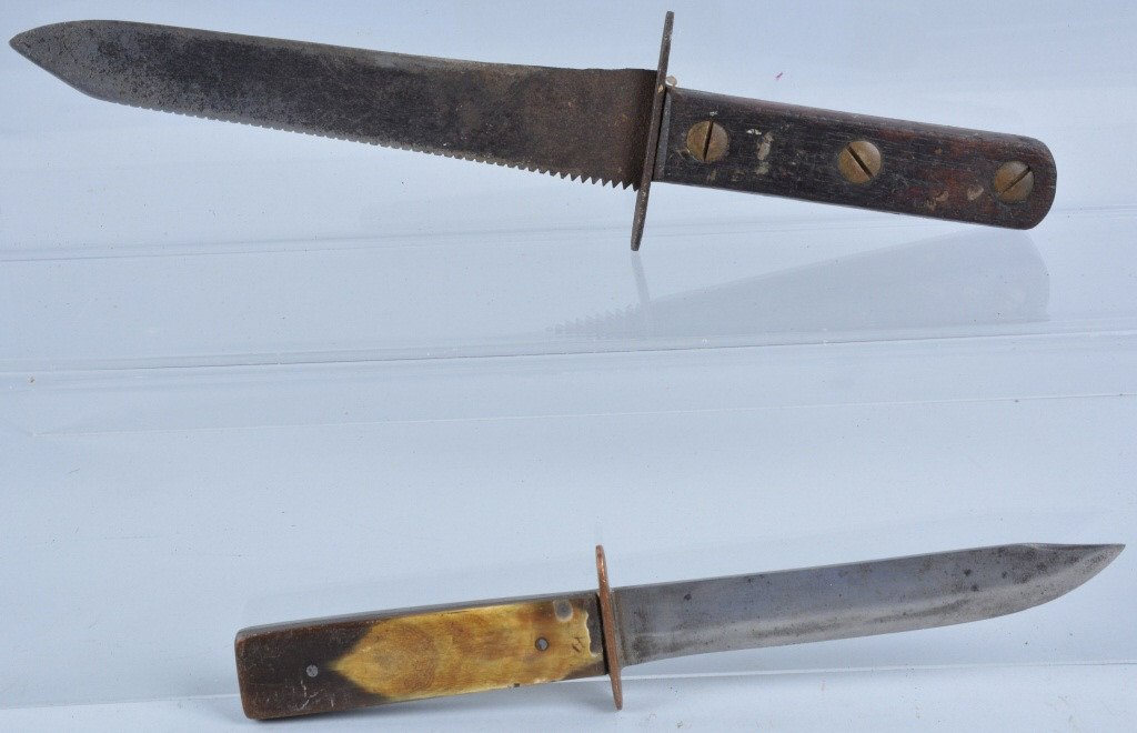 Lot of 2 Antique Side Knives: Smaller one has horn handle and copper guard. Measures 9 3/4". The larger one is about 12" and is made from a saw blade and has an iron guard. Very Good