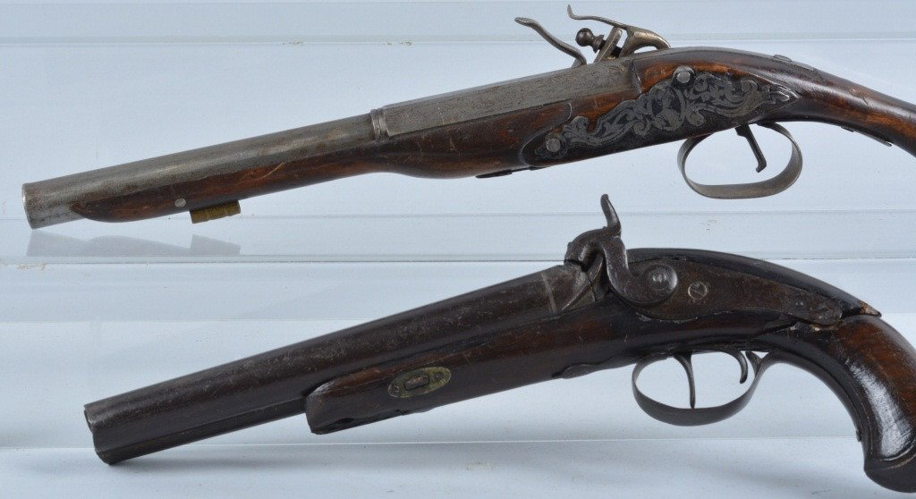 Lot of 2 Black Powder Pistols, Vintage: Lot includes a 1854 dated Spanish double barrel percussion pistol , along with a flint lock pistol that appears to be a mid east decorator. Antique double barrel has cracks to stock, and hammer, bendi