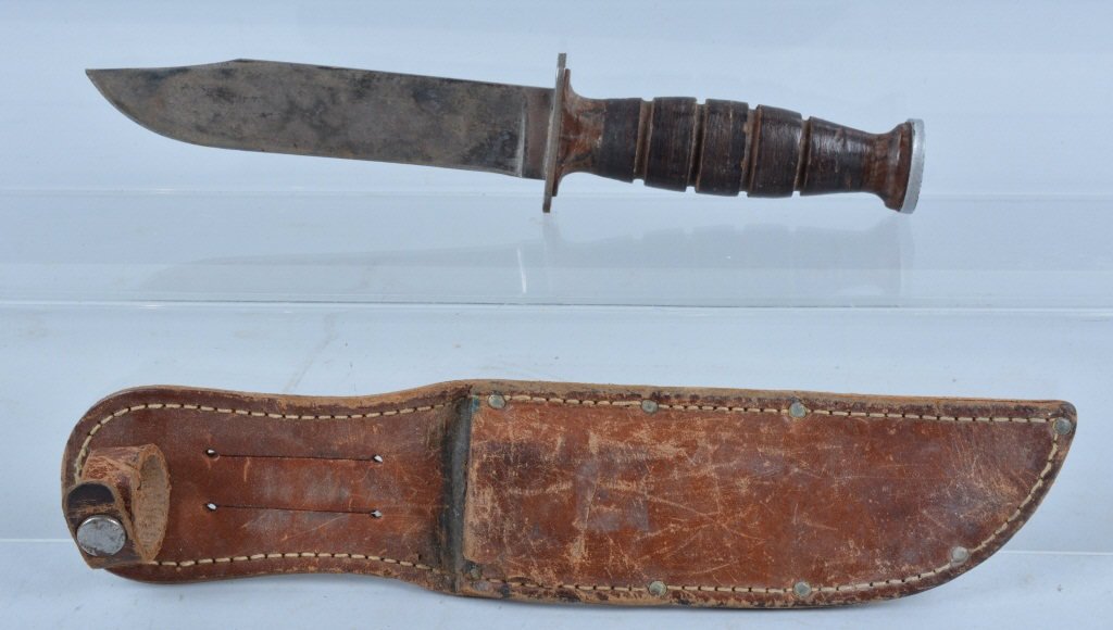 WW2 Kabar Knife and Sheath: 10 1/2" long with a 6" blade. Marked Kabar NY on guard. Very Good