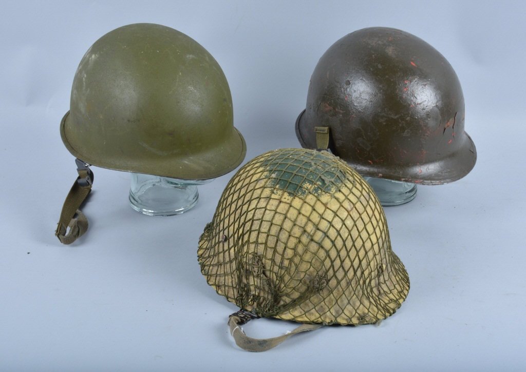Lot of 2 M1 Helmets & Liners: One is a front seam, with netting over liner, the other is a rear seam. Both have swivel bales. One is Good, the other is Excellent