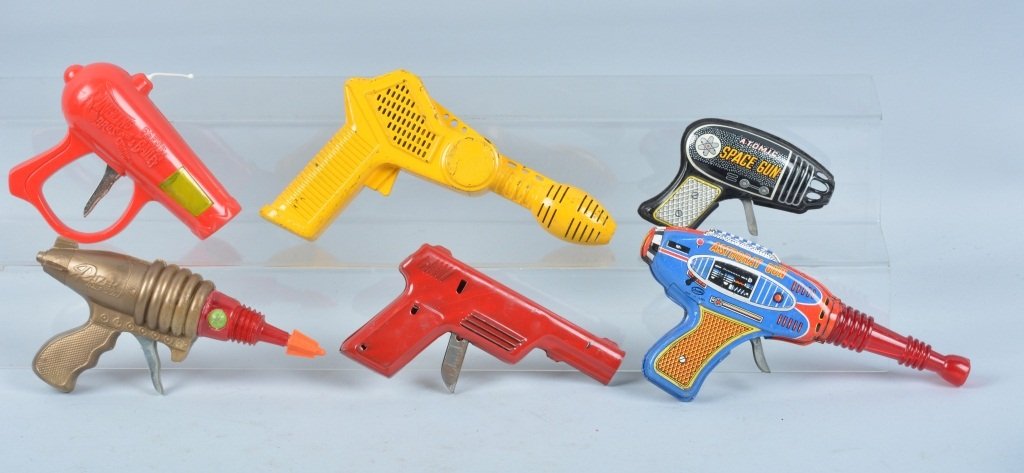 Lot of 6 SPACE GUNS: Includes tin Astroray Gun, Tin Atomic Space Gun, Wyandotte Water Pistol, Plastic Circus Gun, Plastic Razer Ray Gun, and Plastic Yellow Gun. All original. Largest measures 9" Very Good