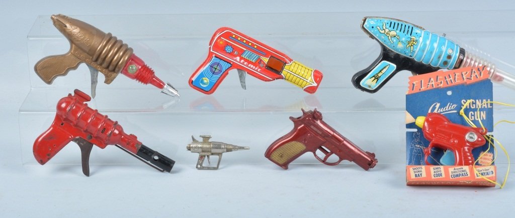 Lot of 7 SPACE GUNS: Includes tin Atomic Gun, Blue Tin Gun, All Metal Products Tin Gun, Small Cap Gun, Plastic Razer Ray Gun, Plastic Eldon Gun, and Flashray Gun on Card. Very Good-Excellent