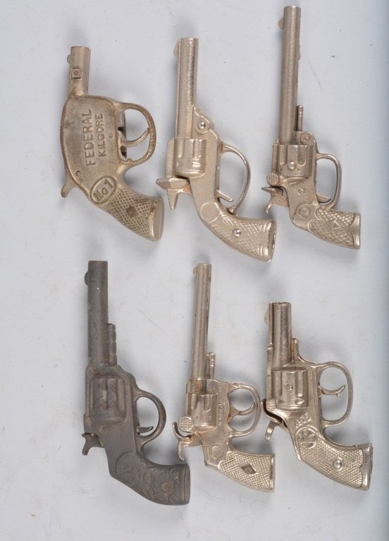 Lot of 6 EARLY CAST IRON CAP GUNS: Includes Ace, Federal Kilgore, Bigger Bang, P, Brono, and Flower Handle Gun. All original. Largest measures 7" Very Good-Excellent