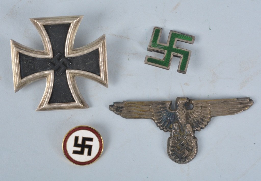 Lot of 4 Nazi Germany Items: Lot includes Iron Cross, green enameled pin marked sterling, small enameled pin with the RZ 41 mark, and a eagle hat devise missing a clip. Very Good-Excellent