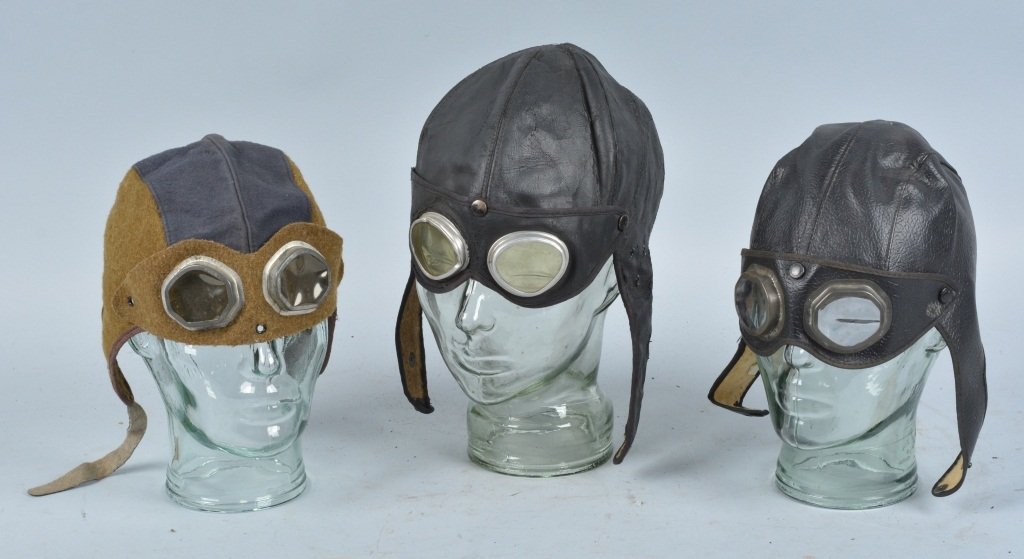 Lot of 3 WW2 Child's Pilots Helmets: Nice grouping with 2 leather, and one wool helmet. Light wear. Very Good-Excellent