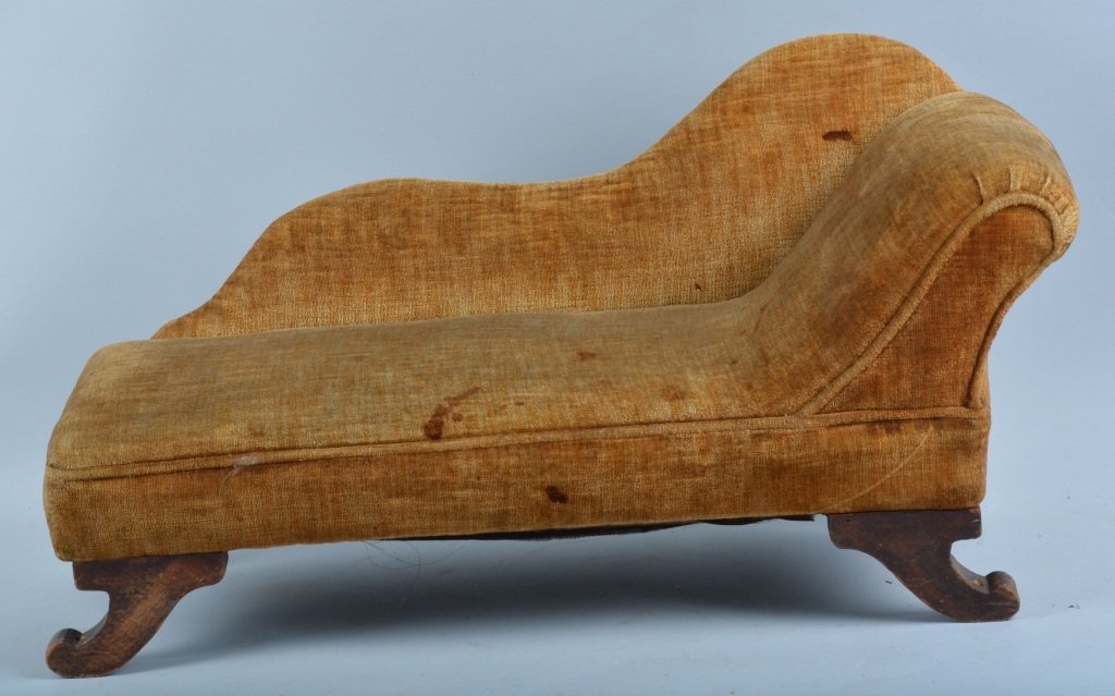 Miniature Victorian Style Fainting Couch: Measures about 28" long and has a wood frame and legs, and upholstered cushion and back. Has general wear and some staining. Probably made for a doll. Good-Very Good