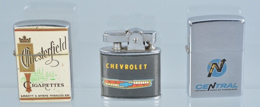 Lot of 3 Advertising Lighters, Vintage: Nice lot with a 1955 Phemix Chevrolet lighter, a Continent Chesterfield Cigarettes Lighter, along with a Zippo Central Bank of Cleveland lighter. Very Good-Excellent