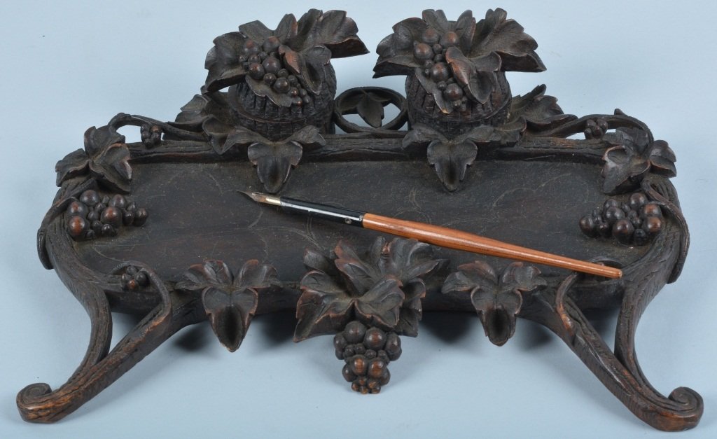 Black Forest Carved Ink Well Desk Set, Vintage: Measures 11 1/2" by 8". Wonderful carvings of grapes and leaves. Has 2 hinged ink wells with no inserts. Includes early wood shaft pen. Excellent