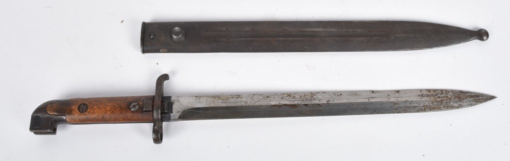 SWEDISH M1884 CARBINE BAYONET & SCABBARD: 13" blade, smooth metal with some staining that should clean off. Blade marked EJ Anchor AB. Metal scabbard is smooth with traces of original finish. Wood grip is very good. Very Good