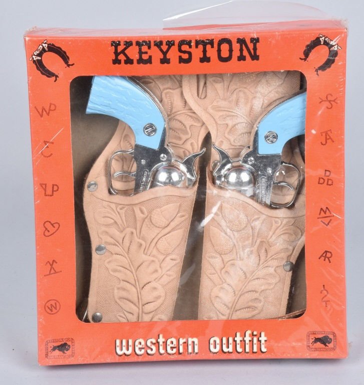 KEYSTONE WESTERN OUTFIT WITH 2 GUNS MIB: Set comes with 2 Nichols Cowpuncher Cap Guns and Holster. New Old Stock sealed in box. Near Mint
