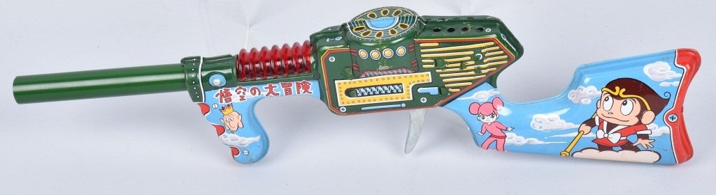 JAPAN Tin Clicker COMIC CHARACTER GUN: Nice Japan tin litho gun with Japanese comic characters. Clicker action not working. Nice colors. 18" Very Good-Ex cellent