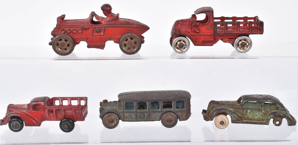 5- CAST IRON VEHICLES: Nice lot of 5 original cast iron toys. Includes Bus, Mack Truck, Boat Tail Racer, Sedan, and Stake Bed Truck. Largest measures 5" Good-Very Good