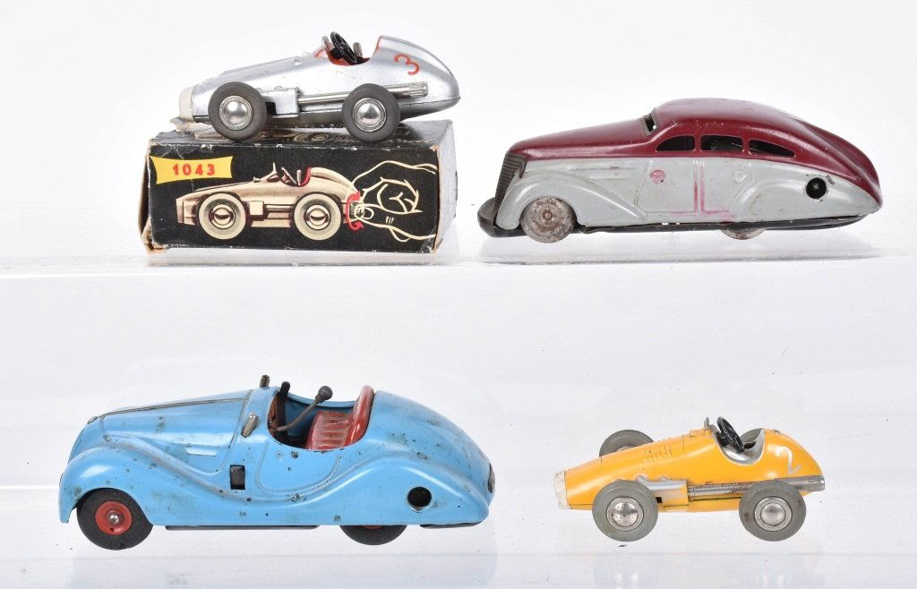 Lot of 4 SCHUCO WINDUP TOYS: Includes Mercedes Micro Racer with Box, Yellow Micro Racer, Examico 4001 missing steering wheel and windshield, and Schuco 1010 not working. Largest measures 5" Very Good-Excellent