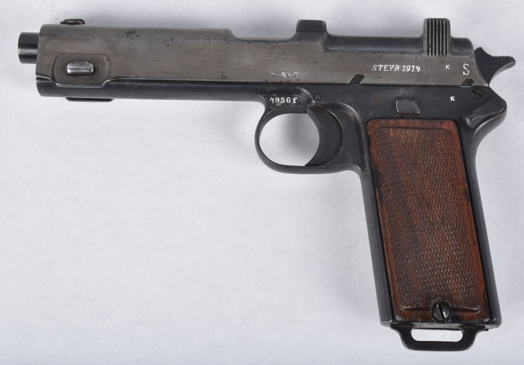 STEYR M1914 9MM PISTOL: SN 4956F, nice markings, very good bore, smooth metal with finish in protected areas. excellent wood grips, action works, but mag is stuck. Very Good