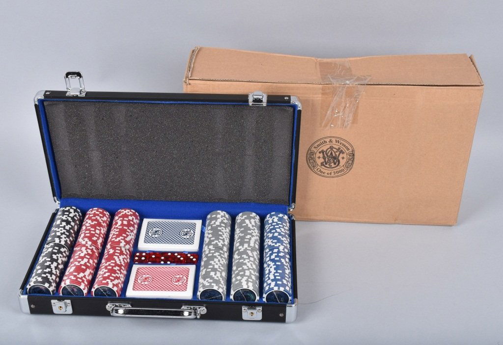 SMITH & WESSON, POKER SET, 300 CHIPS, CARDS, DICE: Great Smith & Wesson poker set in the original aluminum carry case. Set includes 300 clay chips, 2 decks of cards, and 5 dice. Set is unused and is 1 of only 2000 made. Near Mint