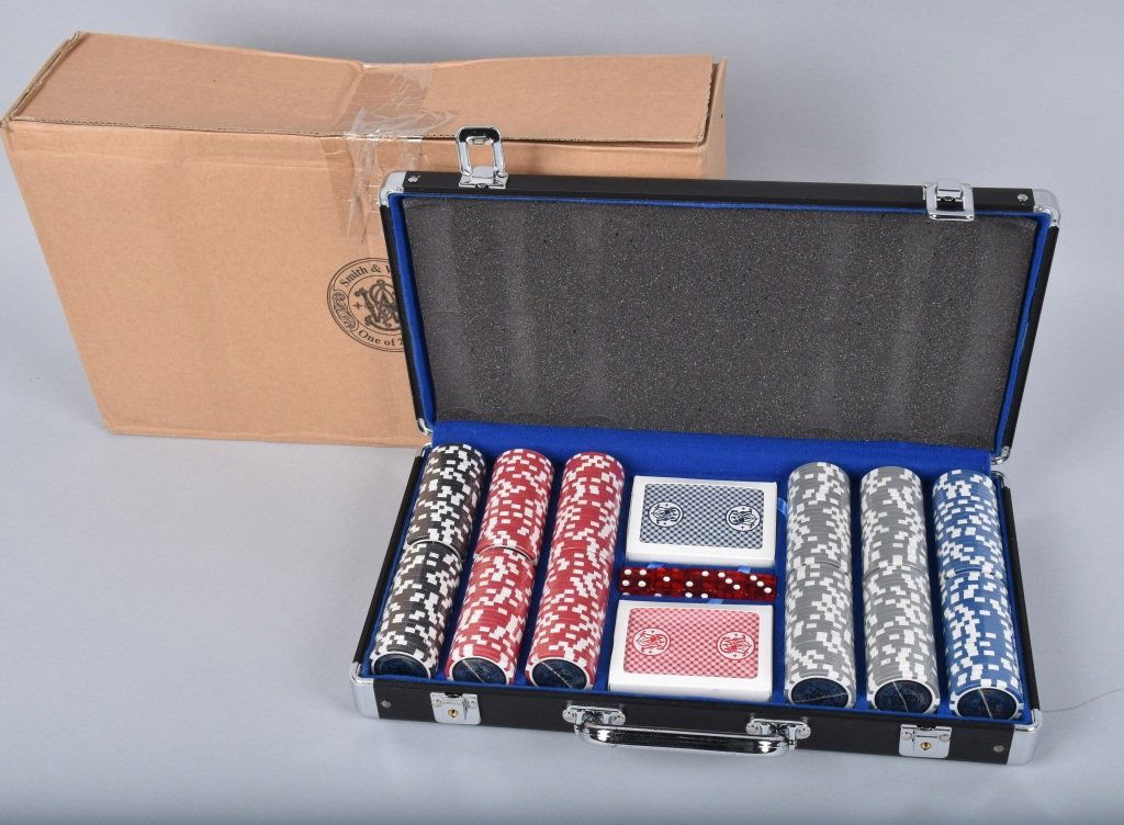 SMITH & WESSON, POKER SET, 300 CHIPS, CARDS, DICE: Great Smith & Wesson poker set in the original aluminum carry case. Set includes 300 clay chips, 2 decks of cards, and 5 dice. Set is unused and is 1 of only 2000 made. Near Mint