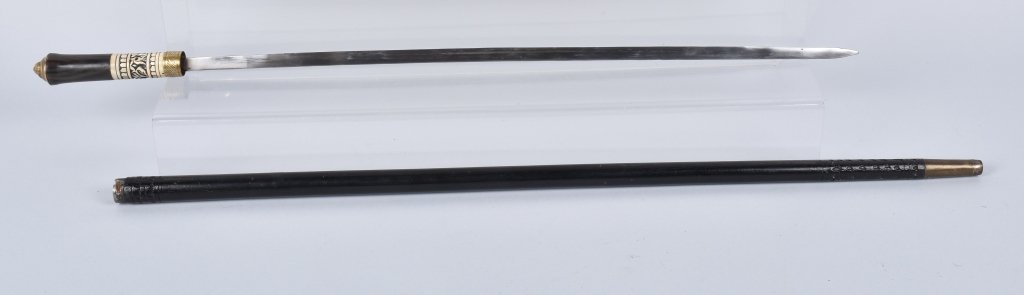 SWORD CANE, DECORATED, VINTAGE: Measures 36", and is nicely made. Has bone decoration and lions head pommel cap. Very Good-Excellent