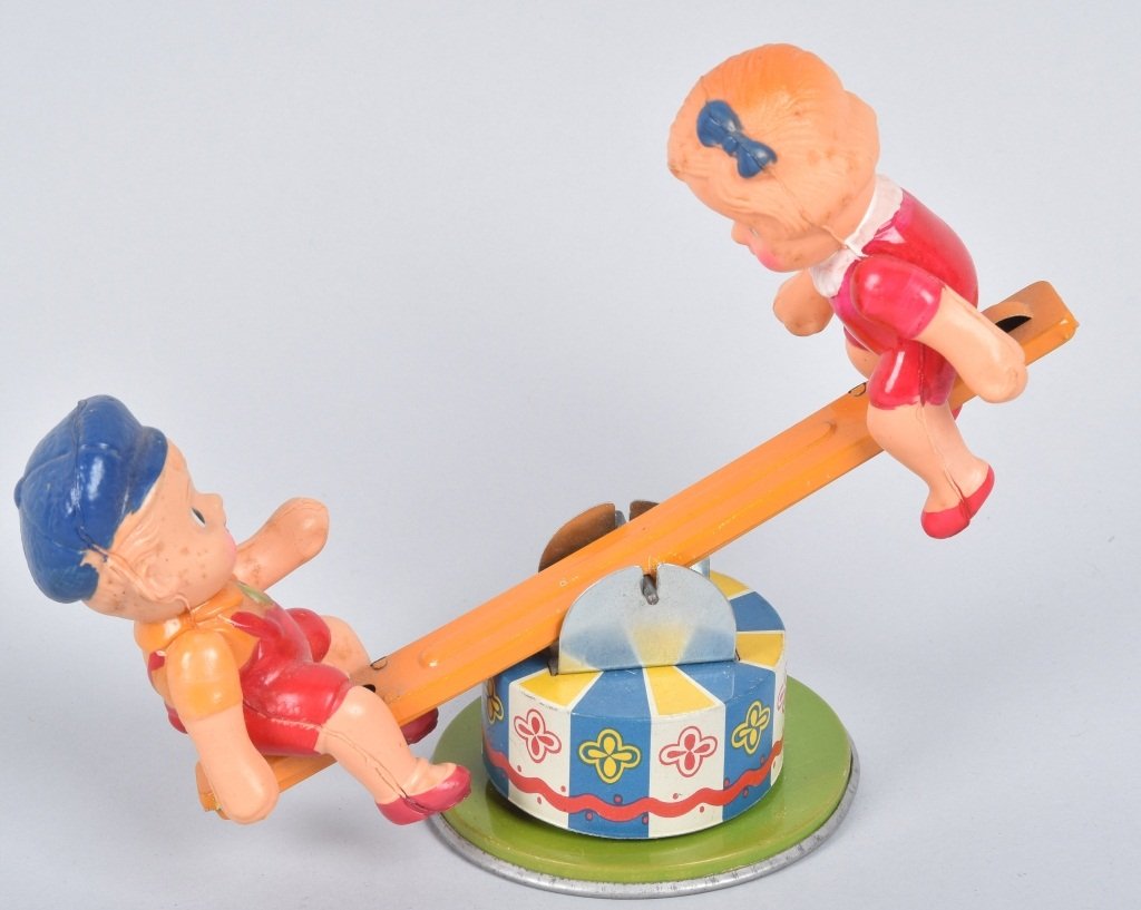 JAPAN Celluloid & Tin Windup KIDS SEE-SAW: Nice tin and celluloid windup Kids on See-Saw. All original with nice colors. Windup works. 7" Excellent