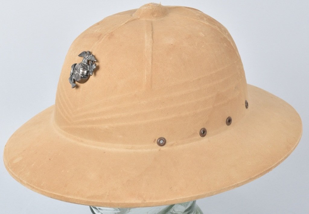 U.S. MARINE CORPS PITH HELMET: Inside of helmet is marked Hercules R2918. Liner is incomplete and helmet shows general wear. Insignia has a push in the globe. Very Good