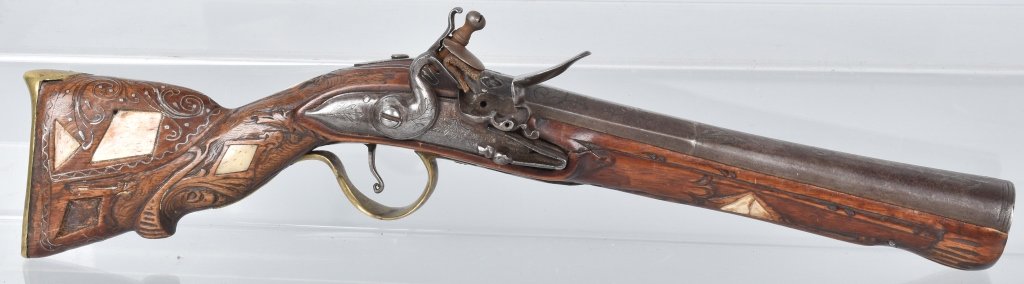 FLINTLOCK BLUNDERBUSS COACH GUN: 16" overall with a 9" flared barrel, lock and barrel are well made and are etched, action works fine, barrel has hall marks at breech. Stock is carved and inlayed with silver wire and bone, missing 3 