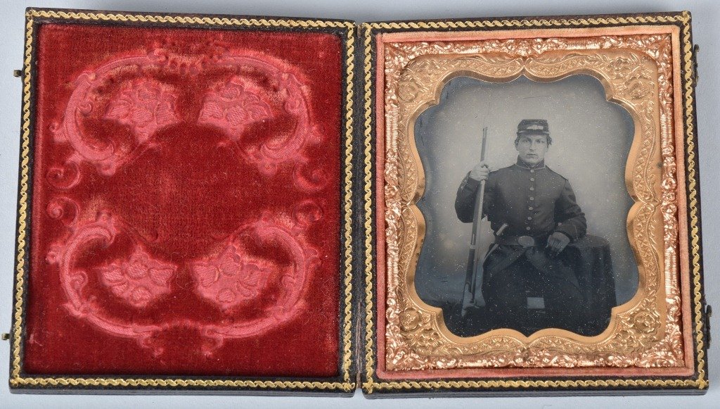 1/6 PLATE AMBROTYPE ARMED CIVIL WAR SOLDIER: Nice Ambrotype image depicting a seated Federal Soldier with musket and bayonet in belt. Nice contrast and clarity. Nice leatherette case. Excellent
