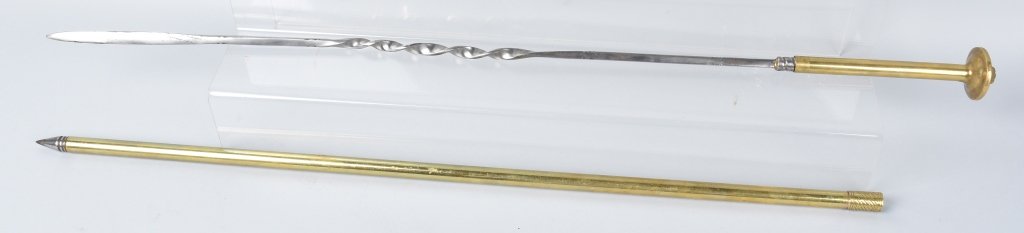 BRASS SWORD CANE WITH TURNED BLADE: 36" overall with a 28" bright turned blade. Nicely made with brass scabbard and handle. The pommel has a lion head. Excellent